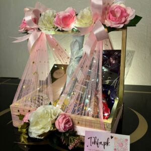 floral engagement gift basket decorated with lights including dress, perfume, bangles and chocolates inside